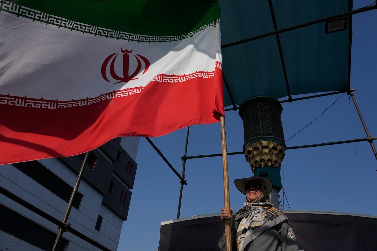 default-345 A woman holds an Iranian flag in Tehran.