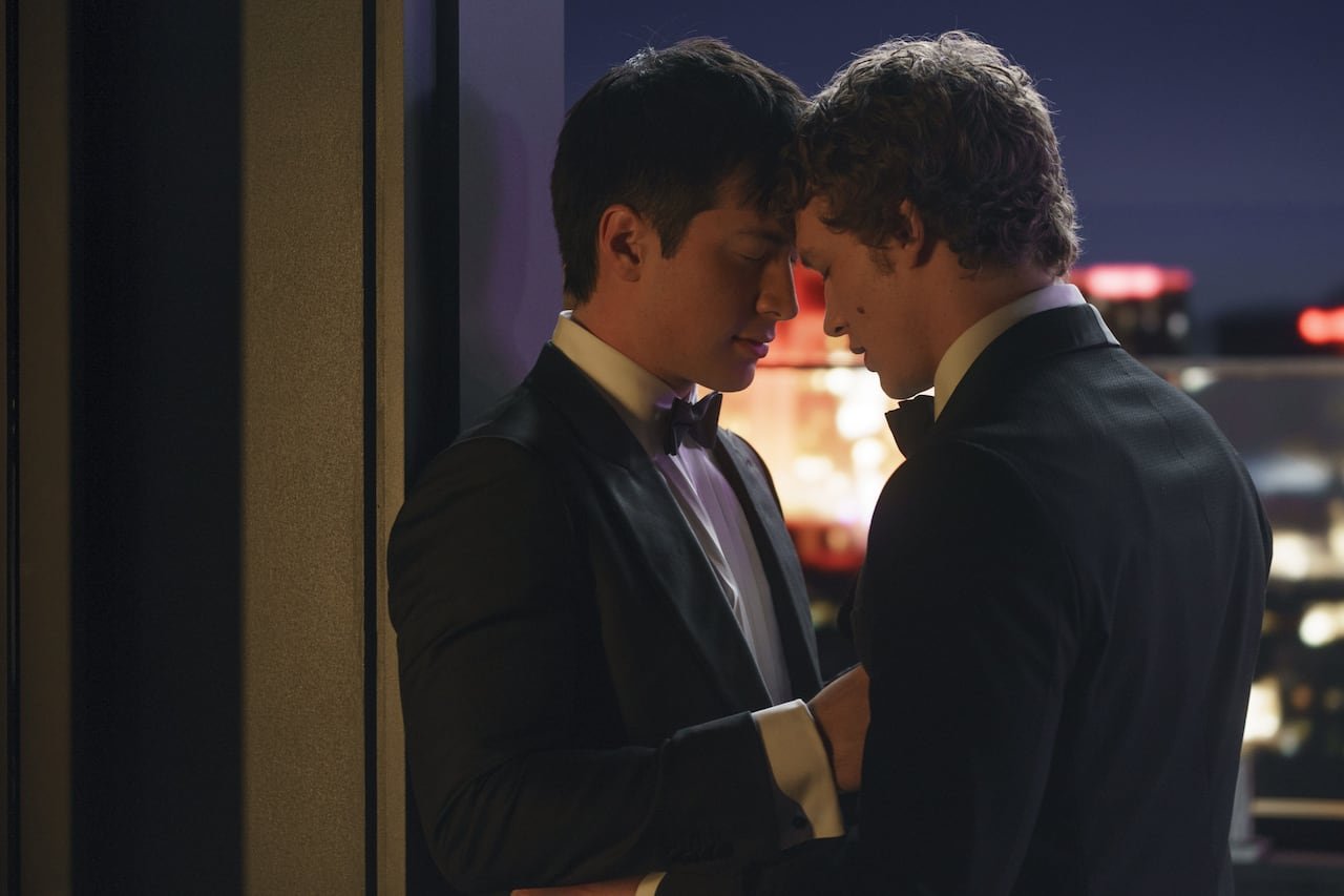 default-407 Two men in tuxedos lean their heads together on a rooftop